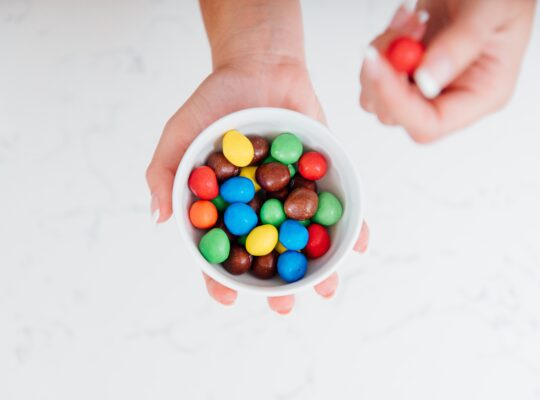holding small bowl of m&ms