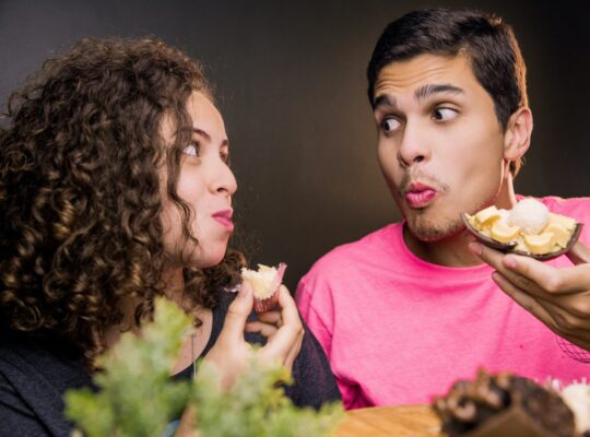 two people eating dessert